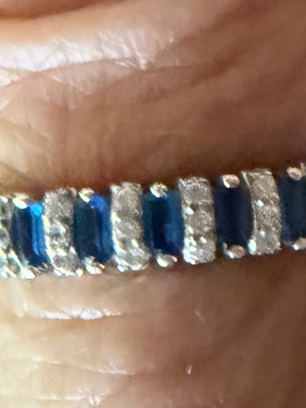 Blue stone baguette and round accent eternity band ring.